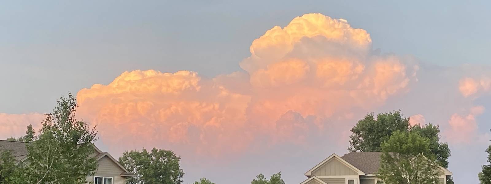 Evening clouds lit orange over the neighborhood