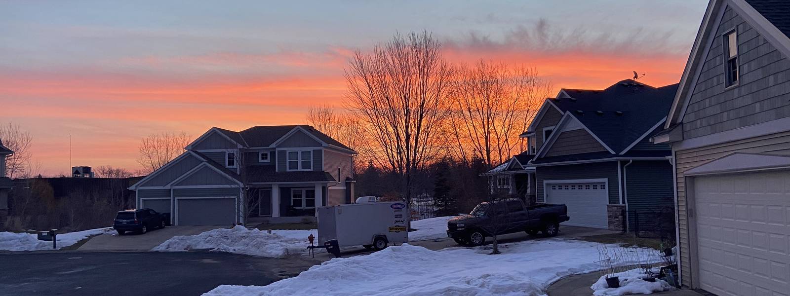 Winter sunset over snowy driveways